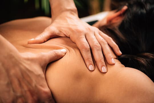 Therapist performing a hands-on back massage